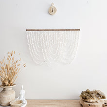 Serena Shell coastal wall hanging. Natural, handcrafted Shell home decor, natural wall decor. Coastal Bohemian home interior style. Create modern coastal boho home aesthetic. Boho interior. Neutral coastal wall art.