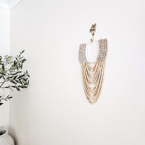 Cowrie shell and wood beaded wall decor necklace. Ideal for Coastal boho, Bohemian home interior style. Natural, #handcrafted wall decor art.